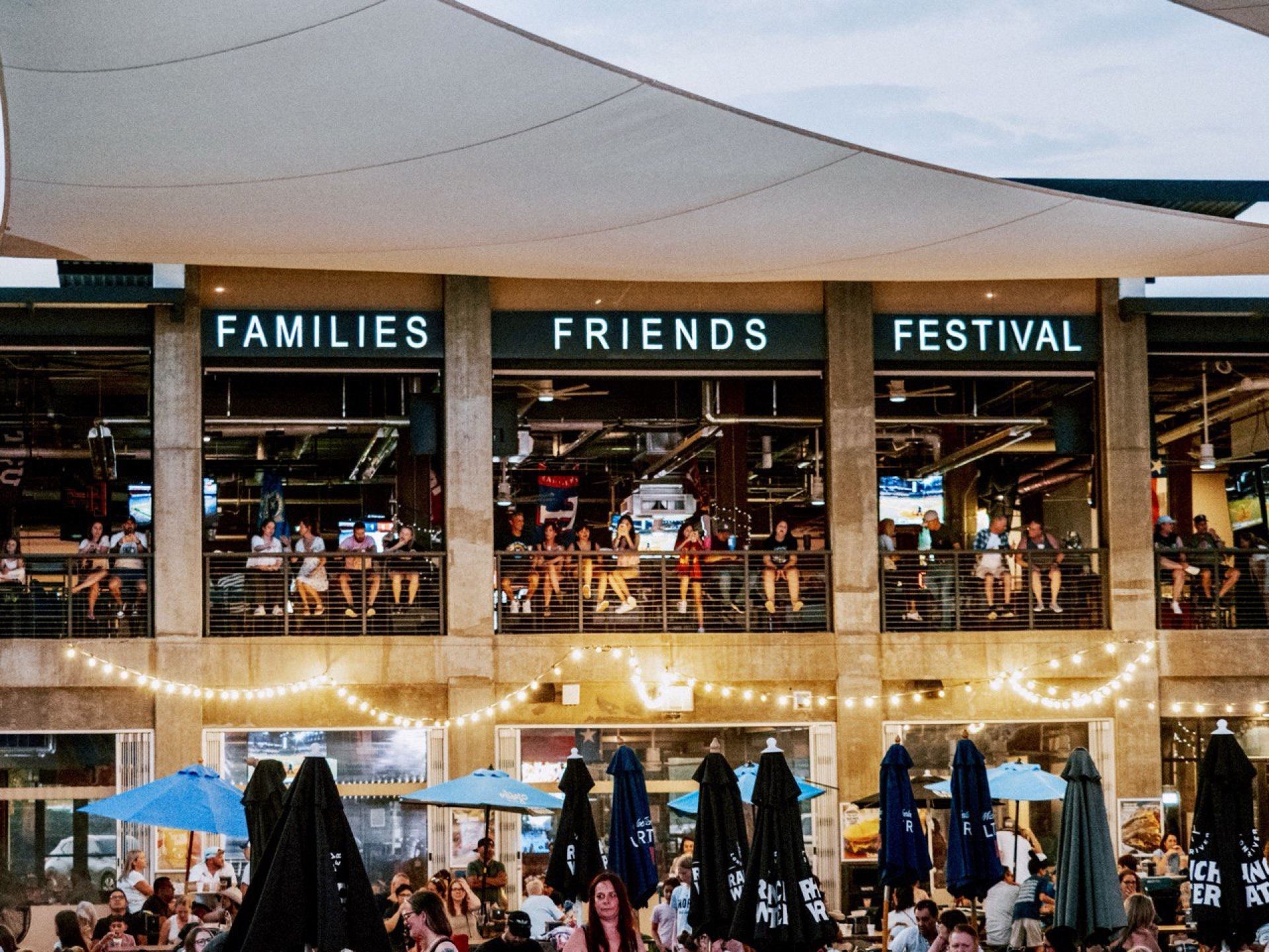 The building at dusk, Families Friends Festival lit above the balcony