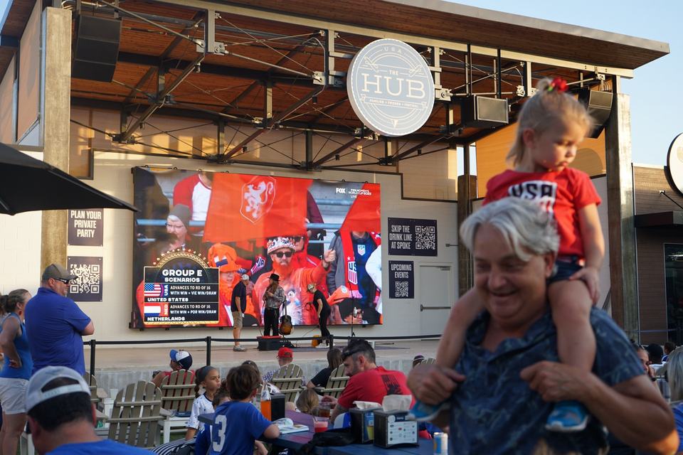 World Cup watch party, a child on a parent's shoulders
